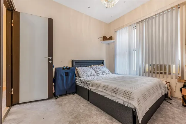 a bedroom with a bed and a window