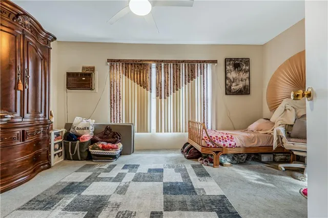 a bedroom with furniture and a window
