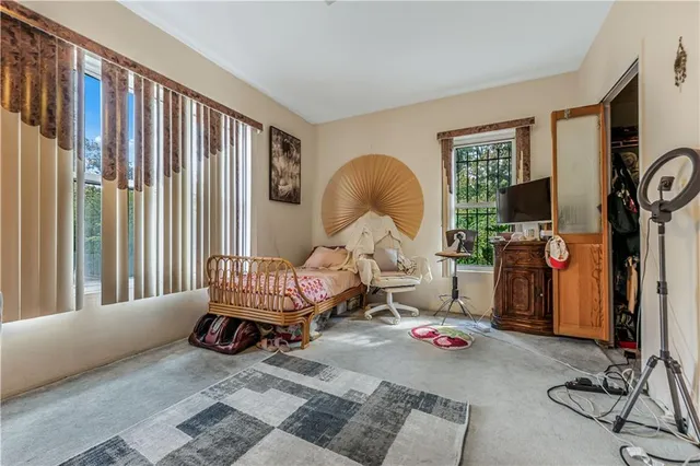a living room with furniture a window and a flat screen tv