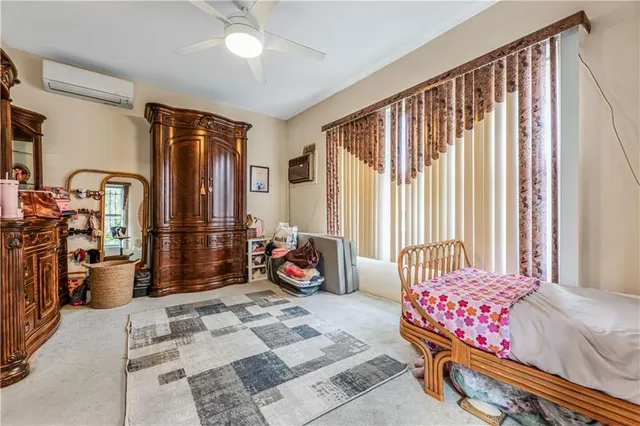 a bedroom with furniture and a large window