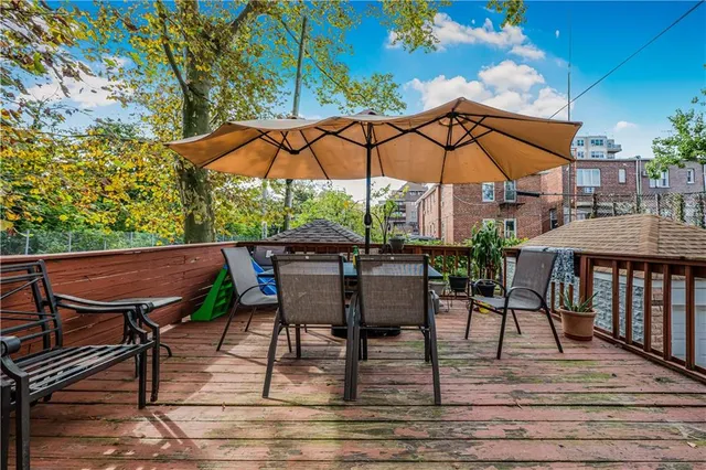 a view of table and chairs under an umbrella
