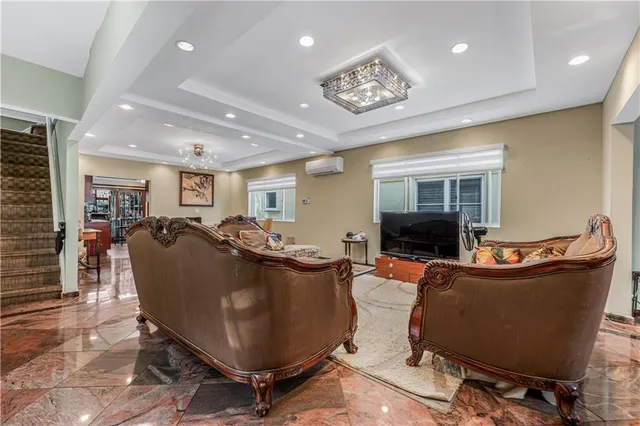 a living room with furniture a dining table and a window