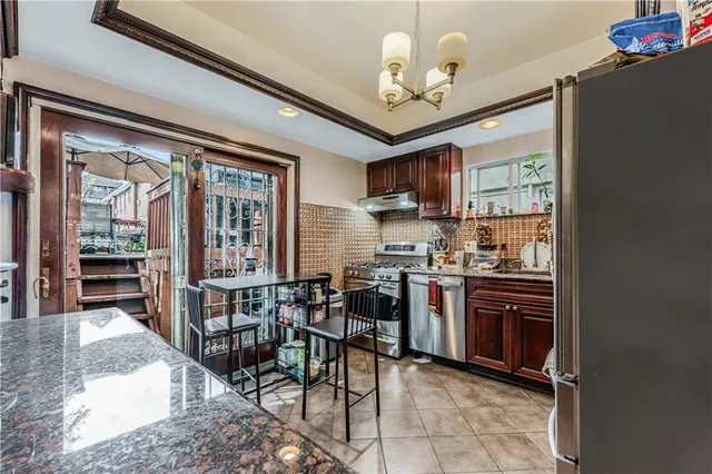 a view of kitchen with sink microwave and refrigerator
