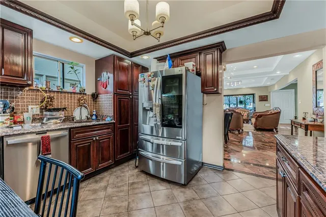 a kitchen with stainless steel appliances granite countertop a stove refrigerator and cabinets