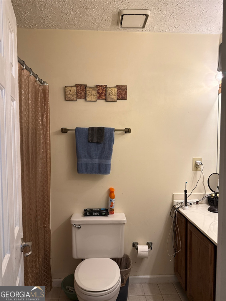 3994 Elm Street Atlanta, GA 30341 - Photo 12 of 15 a bathroom with a toilet a sink and mirror