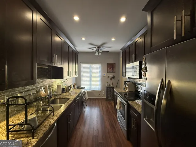 a kitchen with sink stove and refrigerator