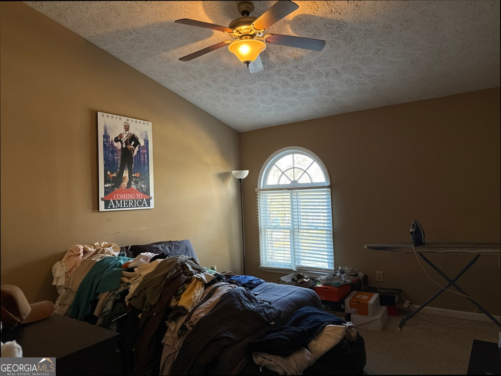 3994 Elm Street Atlanta, GA 30341 - Photo 6 of 15 a bed room with a bed and a chandelier