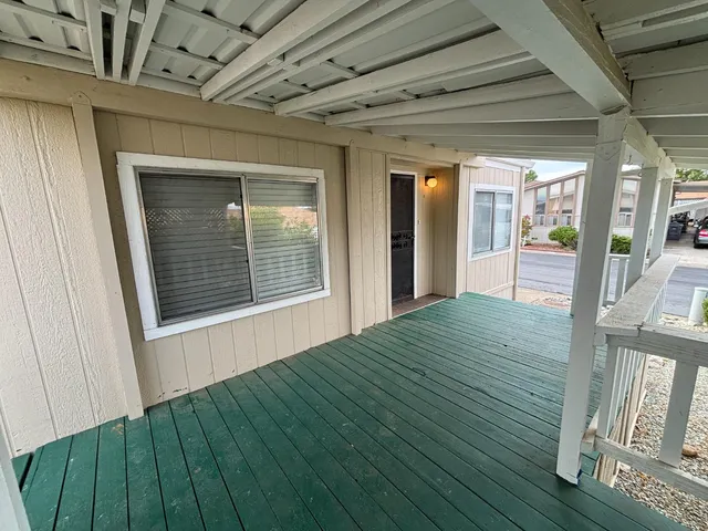 a view of porch with wooden floor