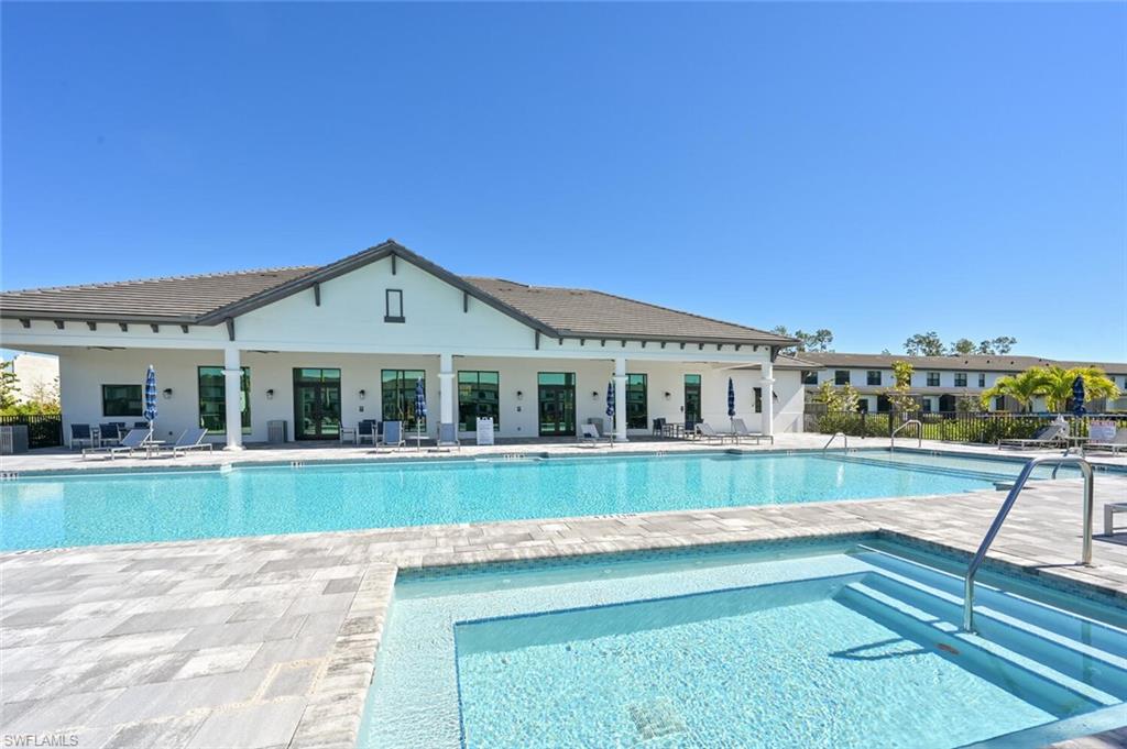 7611 Morgan Way Naples, FL 34119 - Photo 23 of 26 a front view of a house with a yard