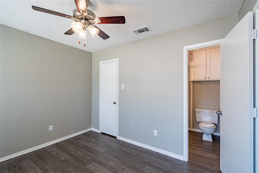 806 Treadwell Court, Unit B Hurst, TX 76053 - Photo 19 of 27 wooden floor in an empty room with a window