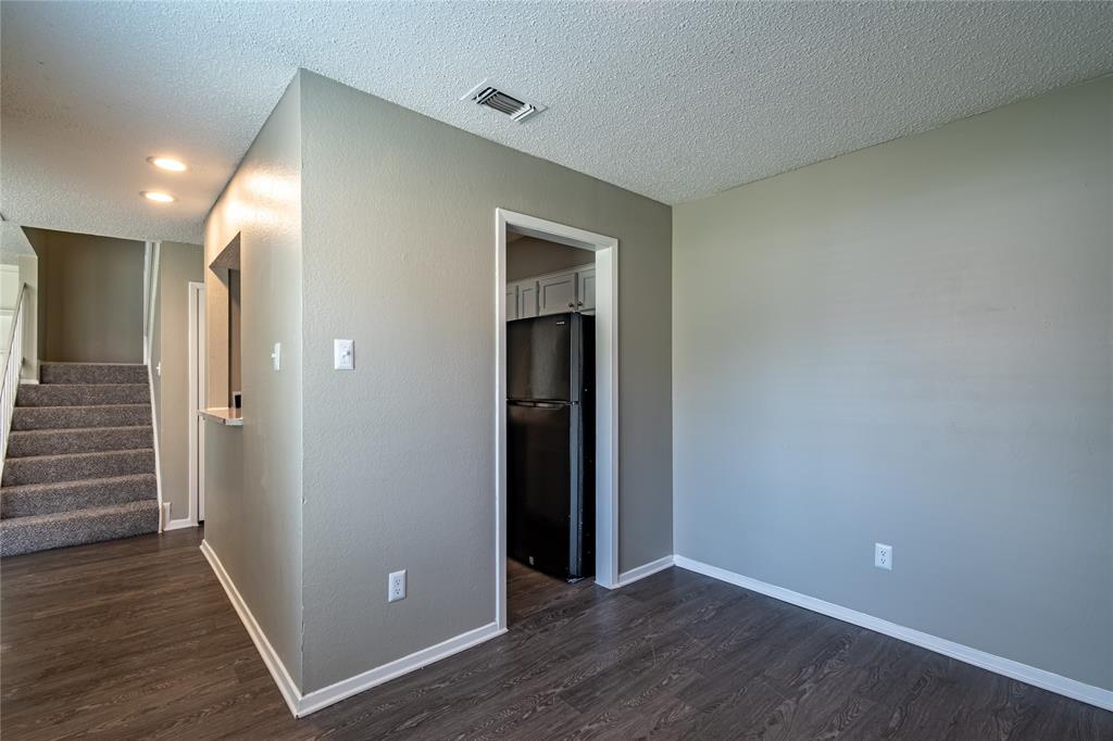 806 Treadwell Court, Unit B Hurst, TX 76053 - Photo 9 of 27 wooden floor in an empty room with wooden floor