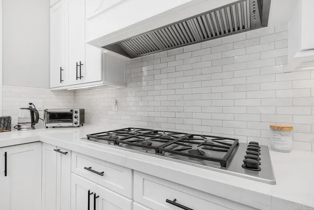 a kitchen with granite countertop a stove and a sink