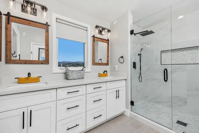 a bathroom with a granite countertop sink a shower and a mirror