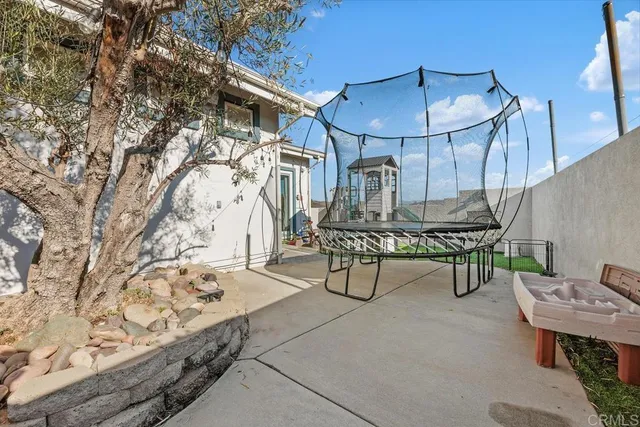 a front view of a house with a tree