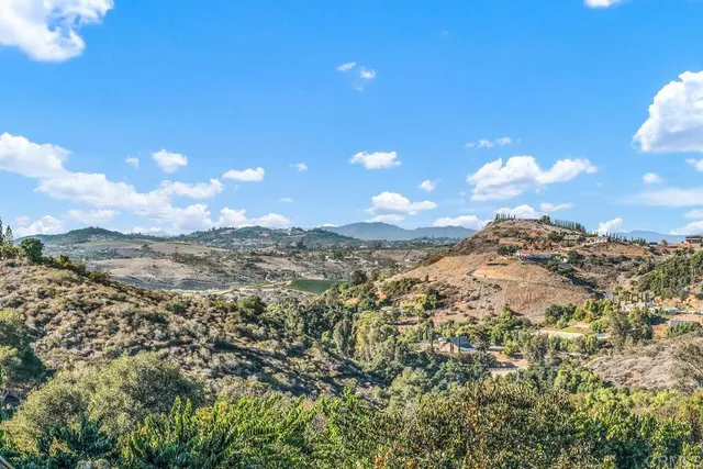 an aerial view of mountain with an ocean