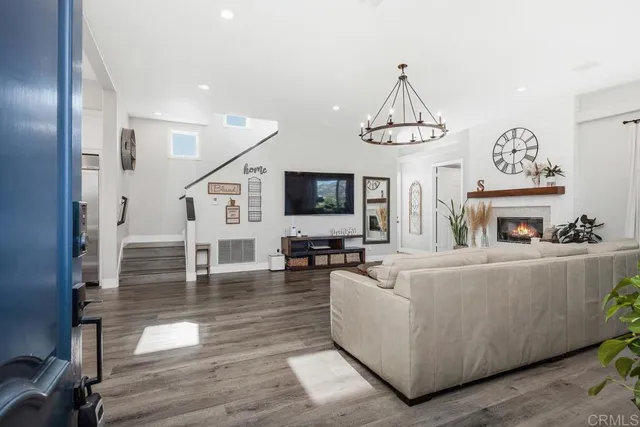 a living room with furniture a fireplace and a flat screen tv