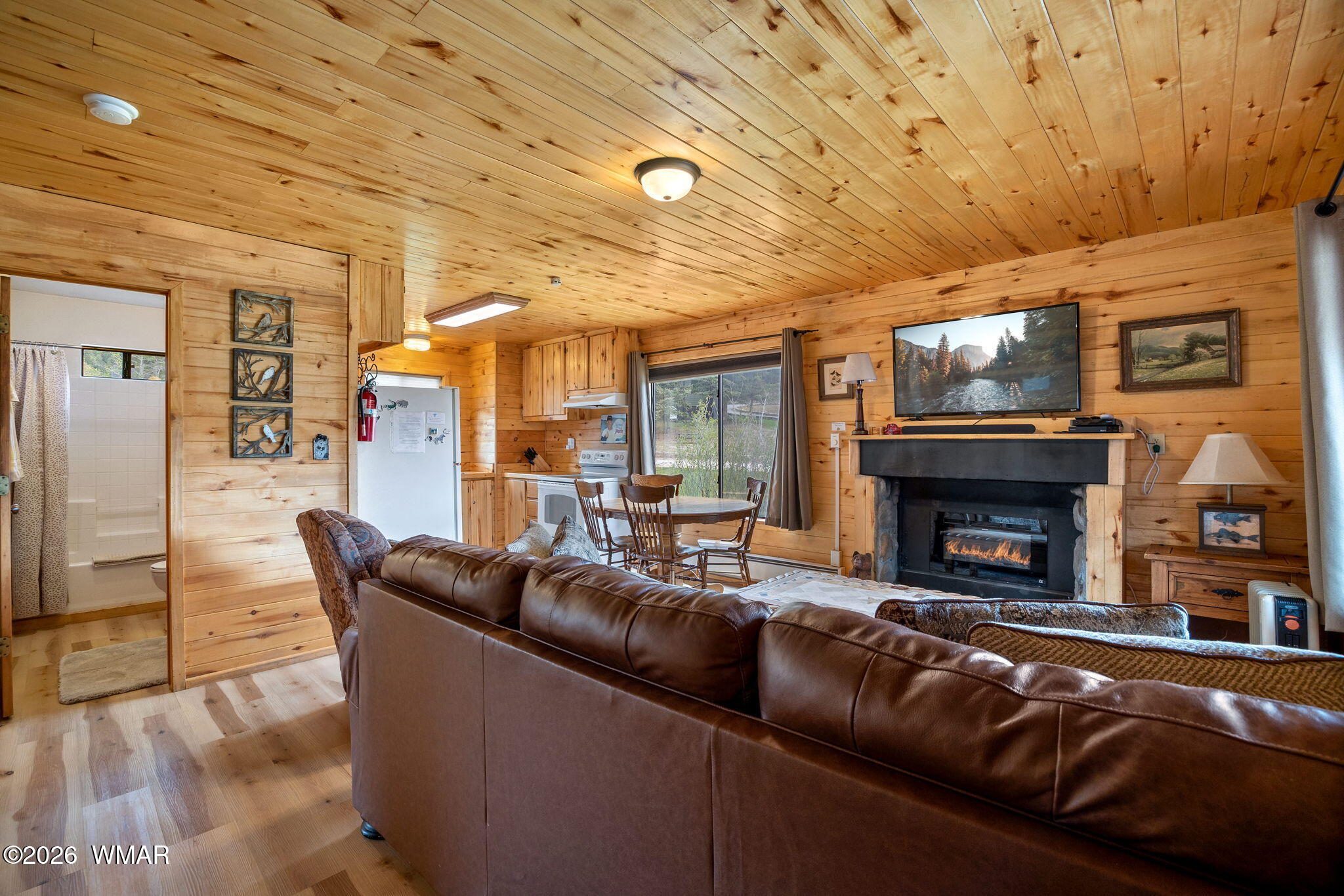 85 Main Street Greer, AZ 85927 - Photo 30 of 55 a living room with furniture and a fireplace