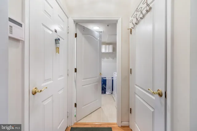 a view of a hallway with wooden floor
