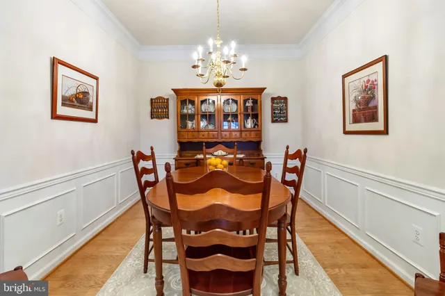 a view of a dining room with furniture and chandelier