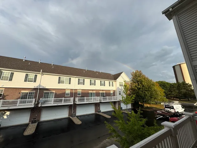 a balcony with wooden benches and trees