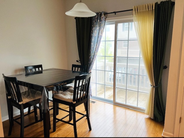 17 East Willow Road, Unit 17 Wheeling, IL 60090 - Photo 6 of 22 a view of a dining room with furniture and a window