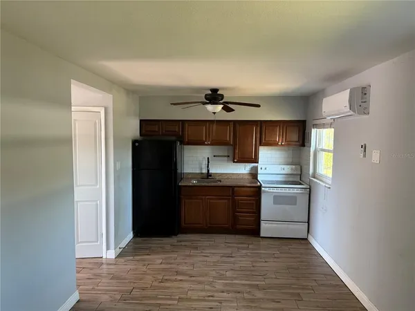 a kitchen with granite countertop a refrigerator and a stove