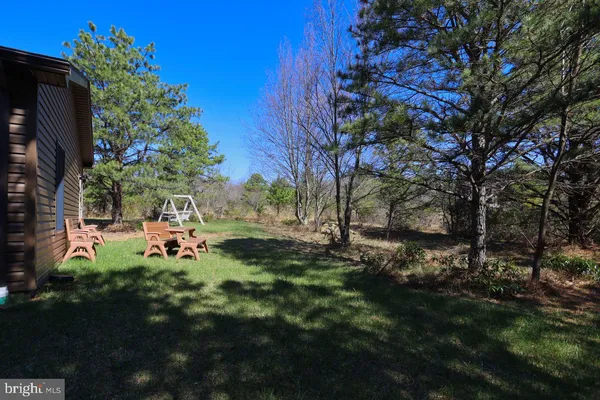 a view of a chair and table on the garden