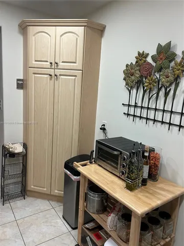 a view of bedroom with furniture and flat screen tv