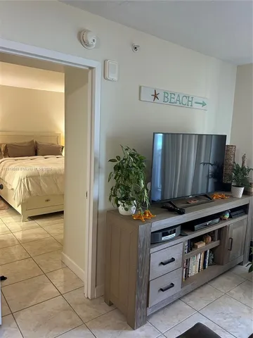 a bathroom with a sink a toilet a mirror and shower