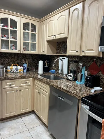 a kitchen with stainless steel appliances granite countertop a stove microwave and oven