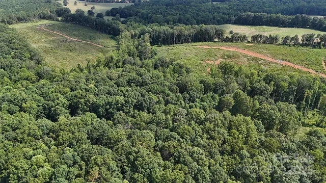 an aerial view of a houses with yard