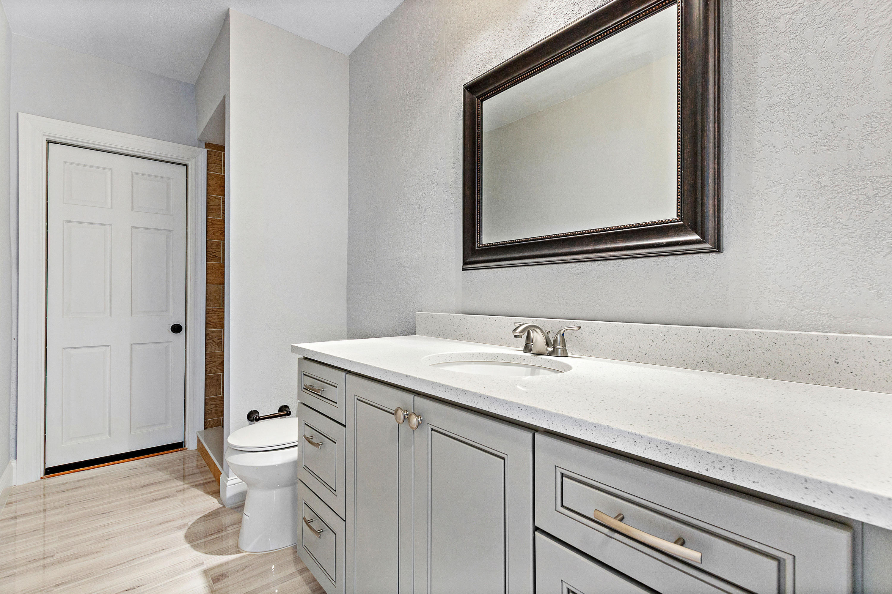 871 Northwest 7th Street Boca Raton, FL 33486 - Photo 16 of 21 a bathroom with a toilet sink and mirror