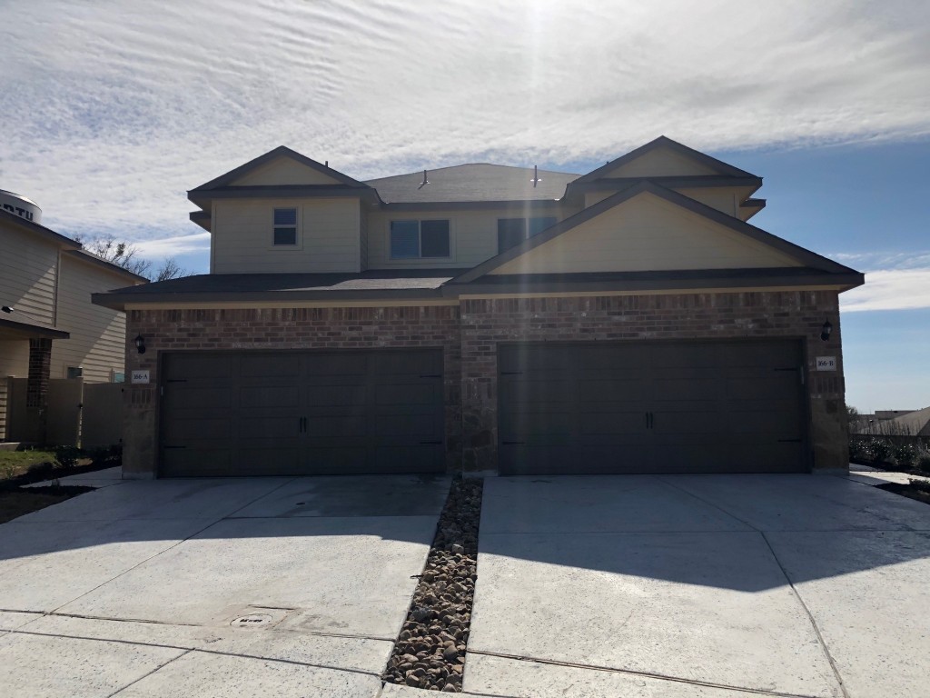 a front view of a house with a garage