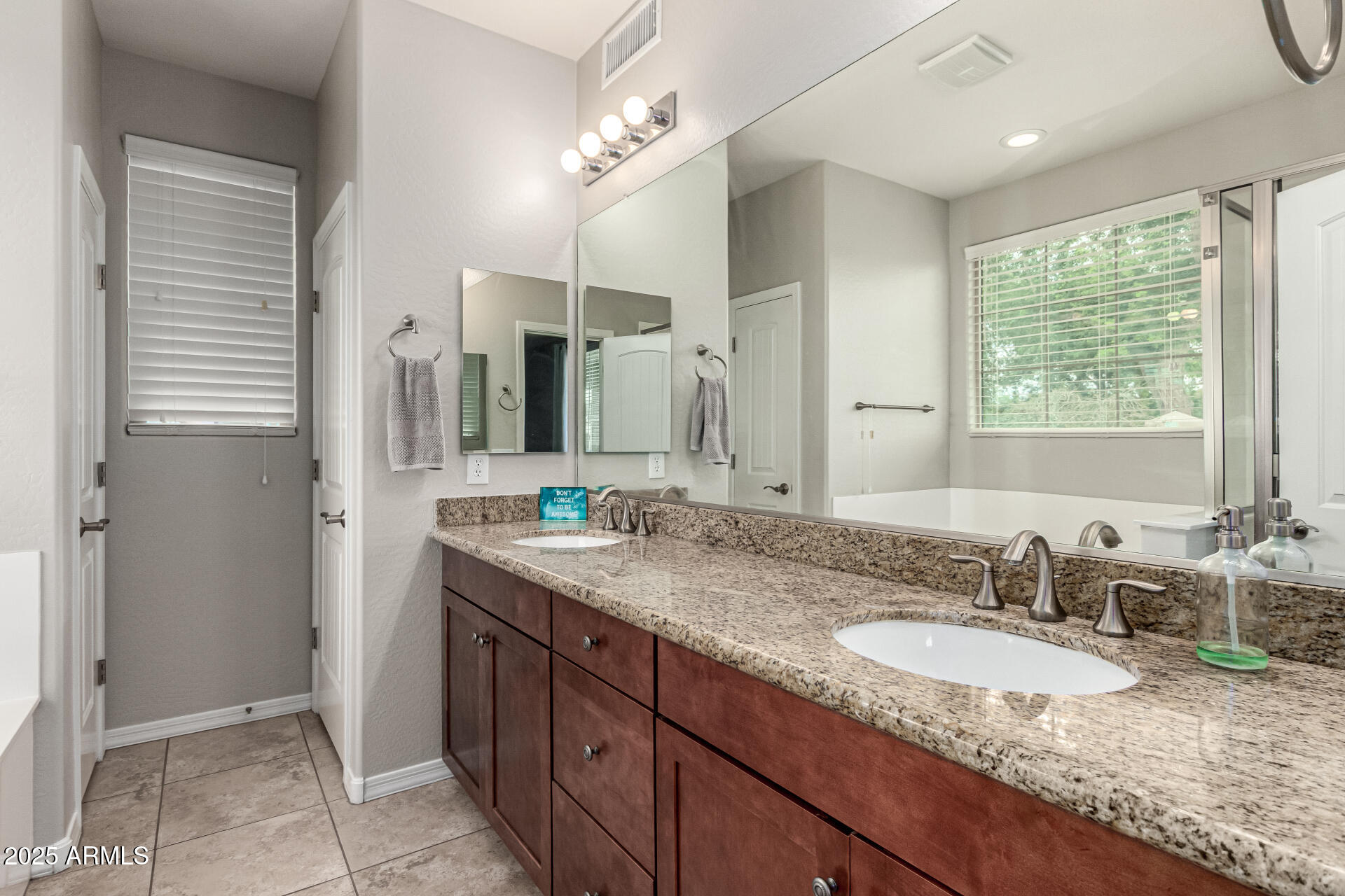 3135 East Ridgewood Lane Gilbert, AZ 85298 - Photo 15 of 39 a bathroom with a granite countertop sink and a mirror