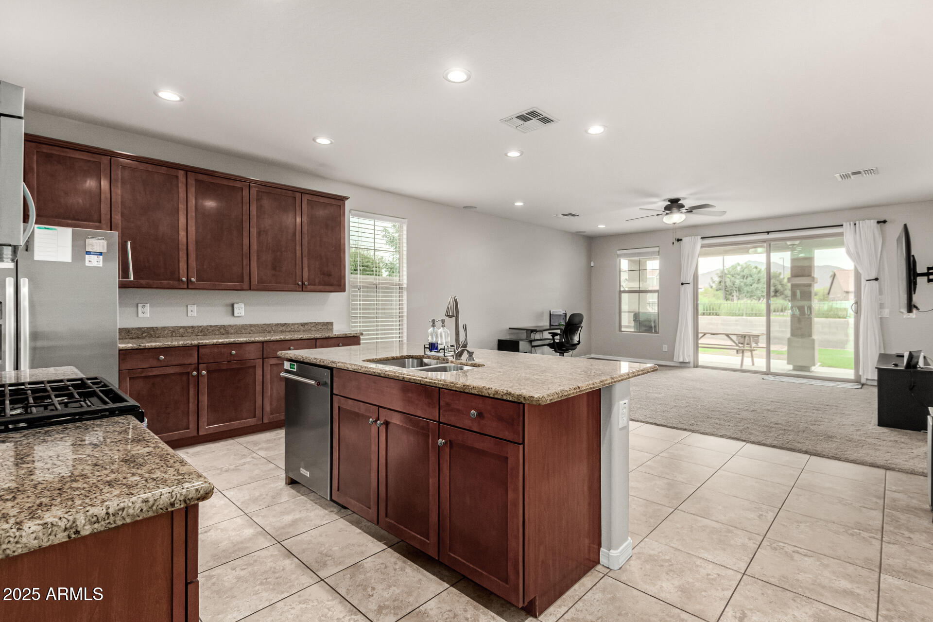 3135 East Ridgewood Lane Gilbert, AZ 85298 - Photo 7 of 39 a kitchen with a stove sink and cabinets