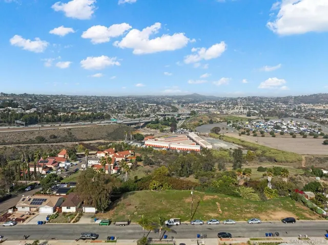 an aerial view of residential building and trees around