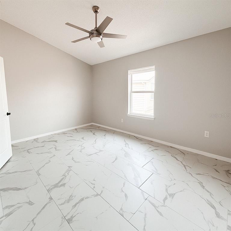 3208 Timberline Road Winter Haven, FL 33880 - Photo 12 of 21 an empty room with windows and fan