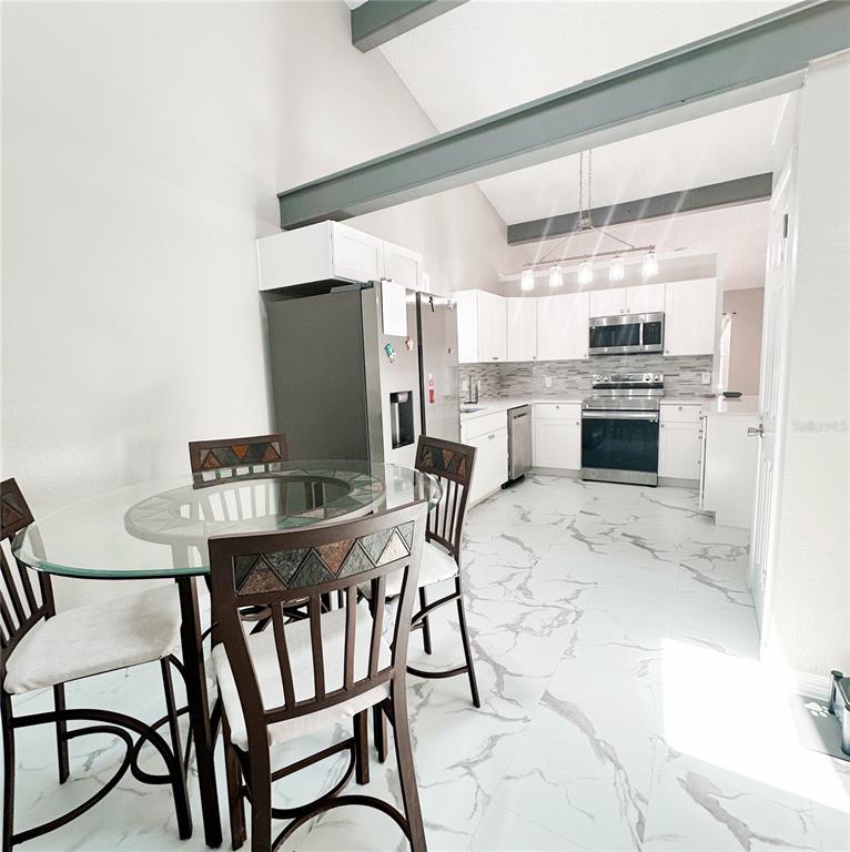 3208 Timberline Road Winter Haven, FL 33880 - Photo 7 of 21 a view of a dining room with furniture and wooden floor