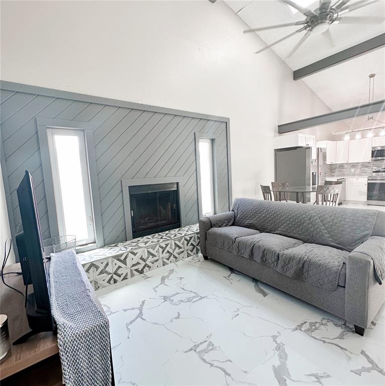 3208 Timberline Road Winter Haven, FL 33880 - Photo 10 of 21 a living room with a couch and a flat screen tv