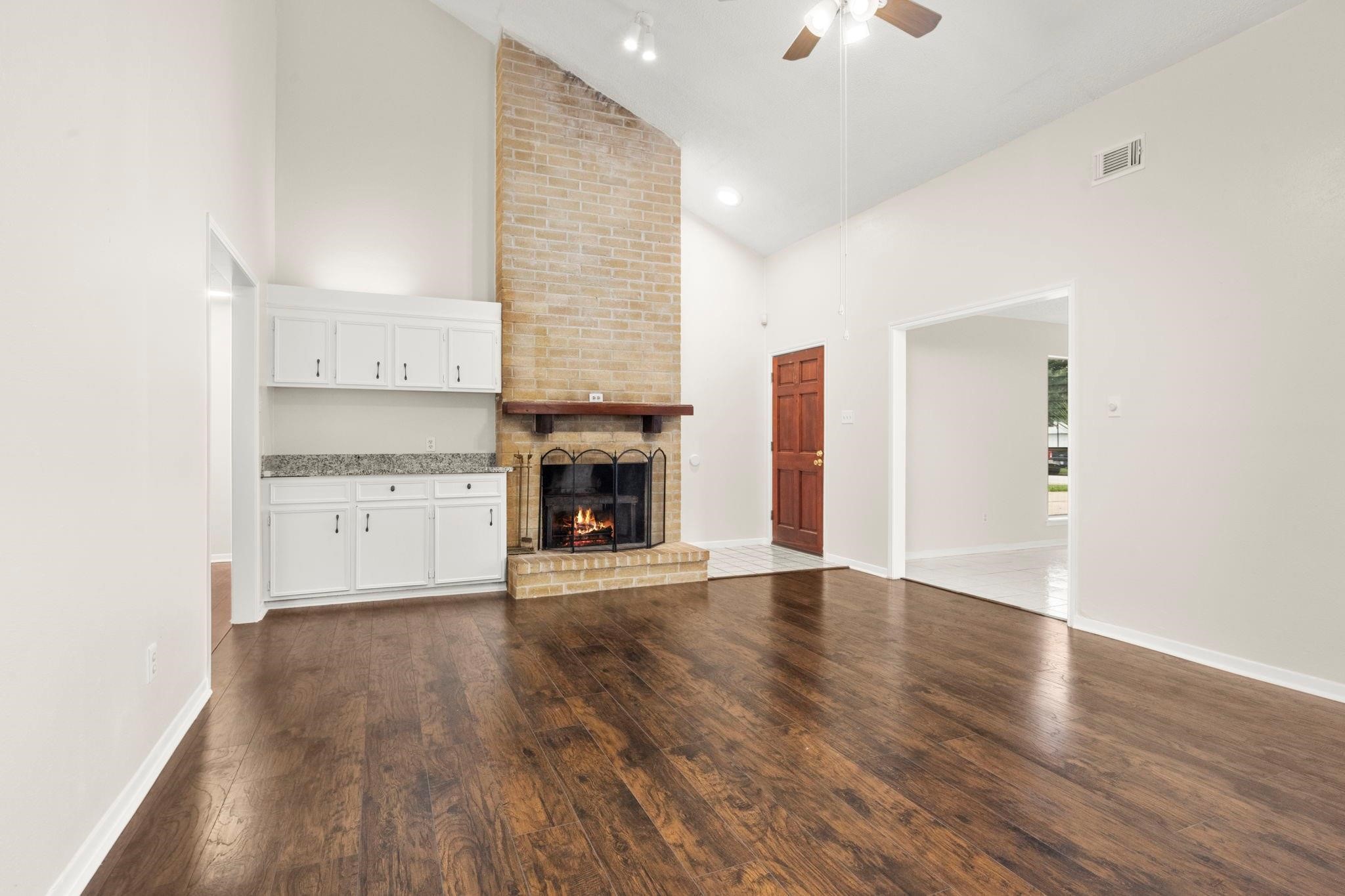 11718 Ridge Run Drive Houston, TX 77064 - Photo 11 of 17 an empty room with wooden floor and fireplace