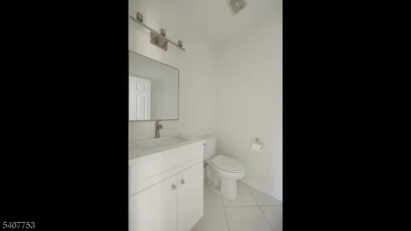 a view of staircase with railing and chandelier