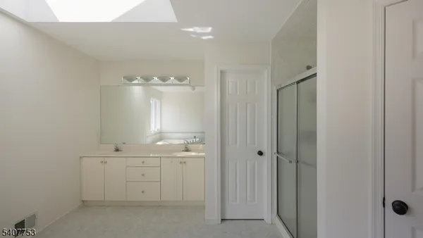 a view of an empty room with a kitchen