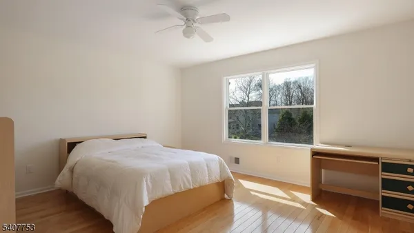 a view of a street with a house and a park