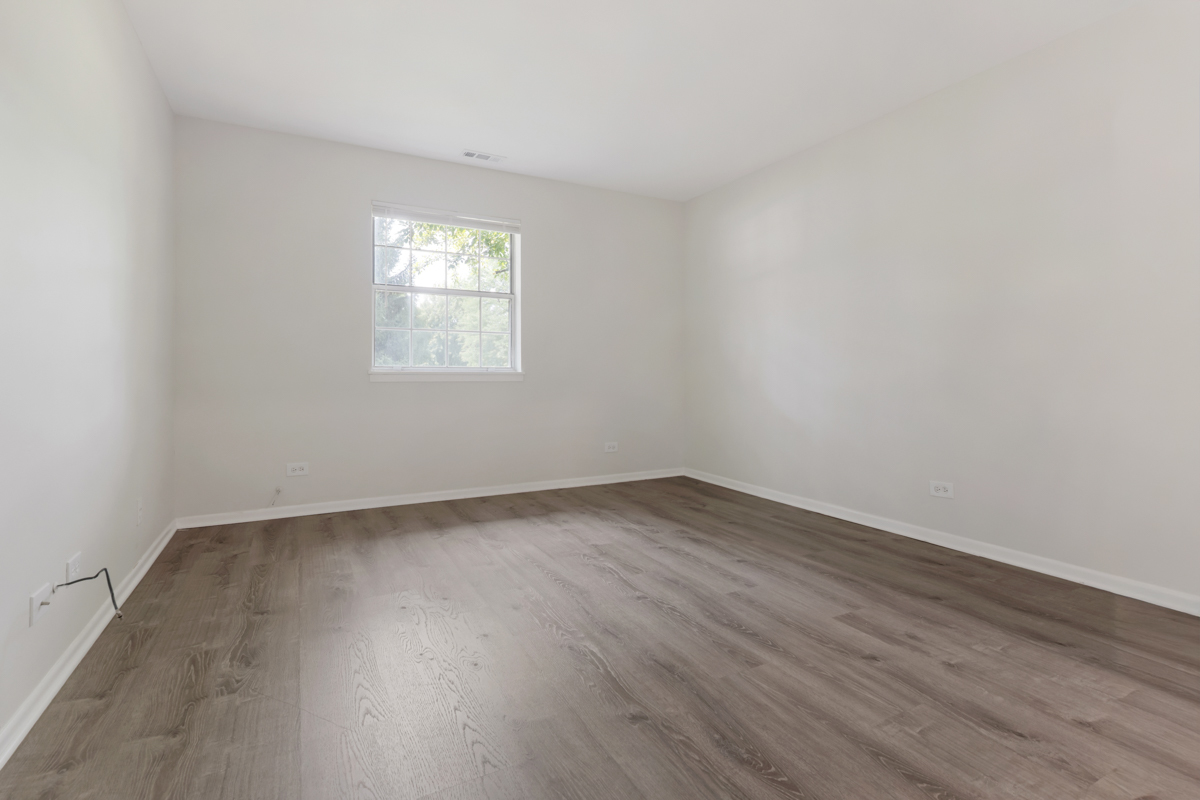 8 Gant Circle, Unit A Streamwood, IL 60107 - Photo 9 of 20 wooden floor in an empty room with a window