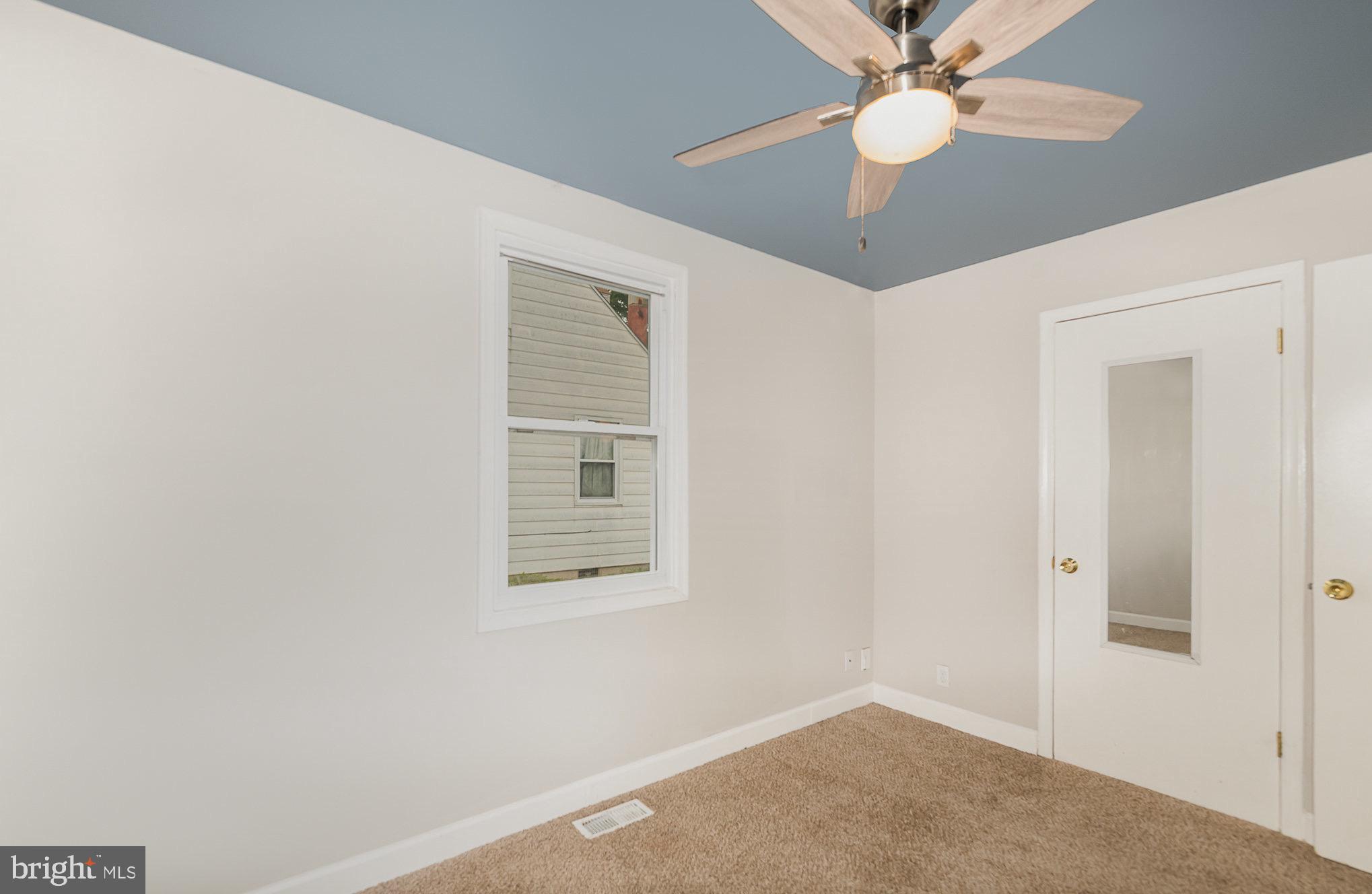 3402 Cornwall Road Dundalk, MD 21222 - Photo 13 of 25 an empty room with windows and fan