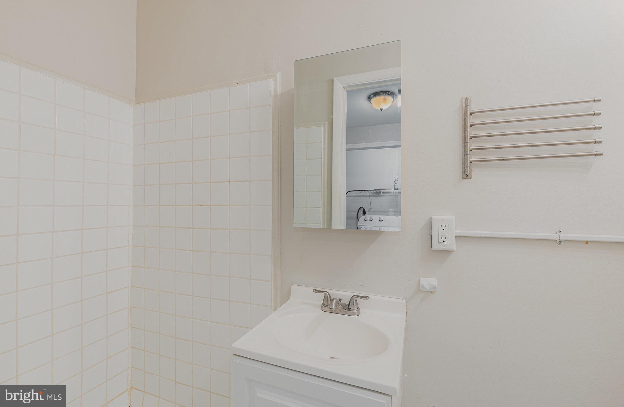 3402 Cornwall Road Dundalk, MD 21222 - Photo 16 of 25 a bathroom with a sink and a mirror