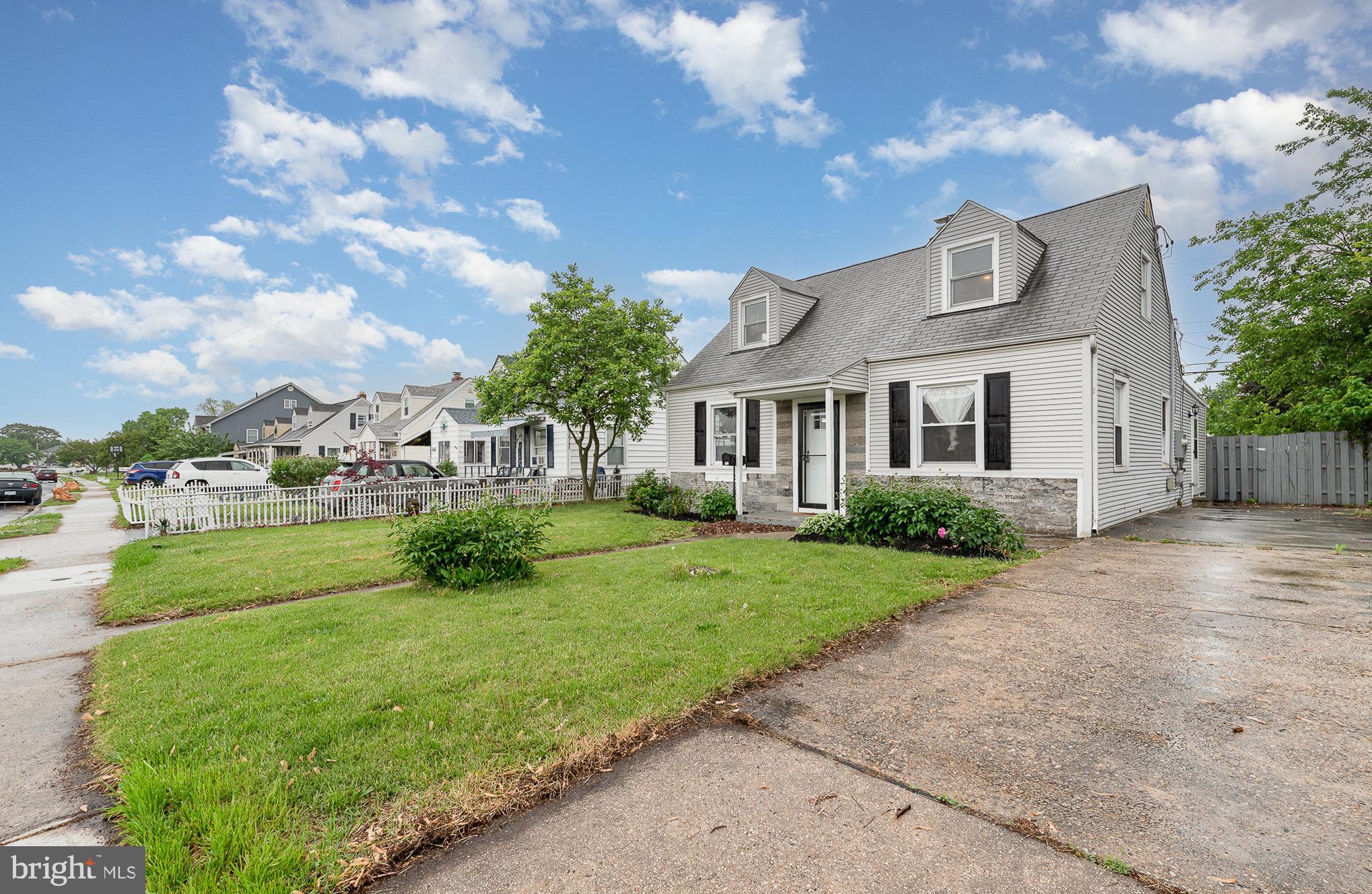 3402 Cornwall Road Dundalk, MD 21222 - Photo 3 of 25 a view of a white house next to a yard with big trees