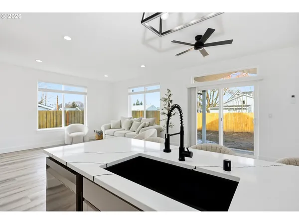 a kitchen with a sink appliances and a window