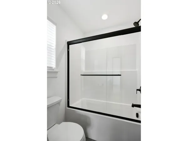 a bathroom with a glass shower door