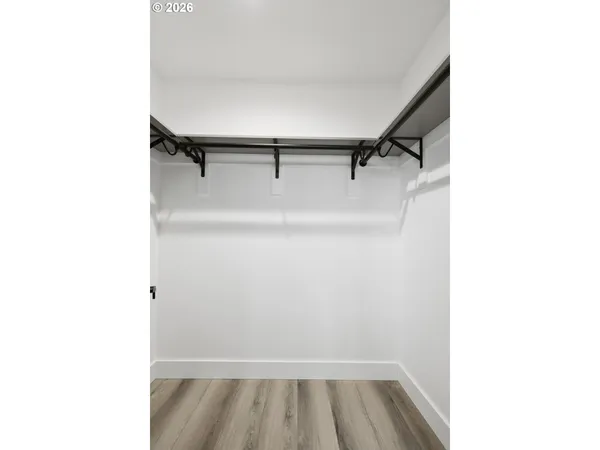 a view of walk in closet with racks on the wall